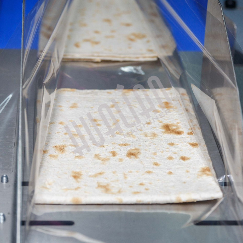 Горизонтальная упаковочная машина DXDZ-600XD (лент. 250 мм, рег.форм., S 400, L 180-500, H-120, трансп.попереч.запайки) Hualian - Купить с доставкой по всей Беларуси